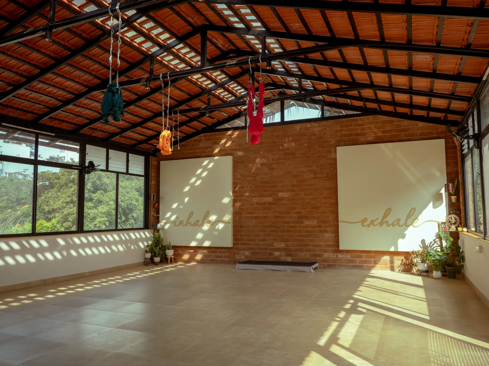 side-by-side of in-studio class and student at home on mat